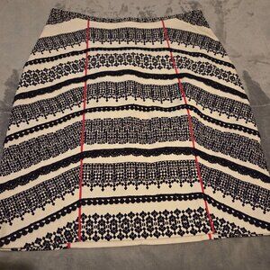 Cream and black pencil skirt with red accents